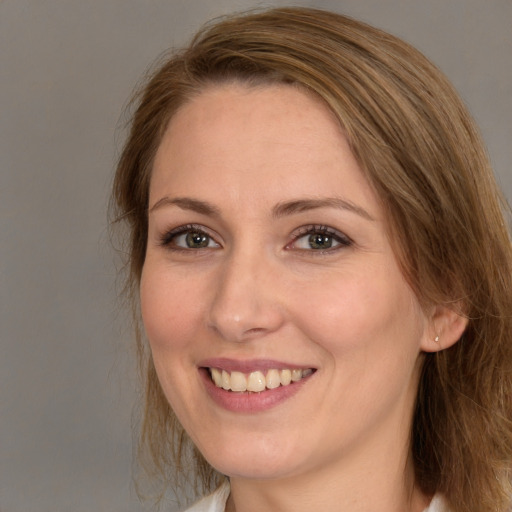 Joyful white young-adult female with medium  brown hair and blue eyes