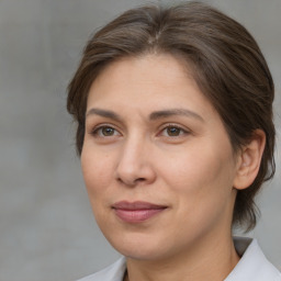 Joyful white adult female with medium  brown hair and brown eyes