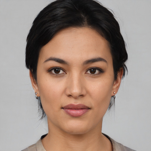 Joyful latino young-adult female with medium  black hair and brown eyes