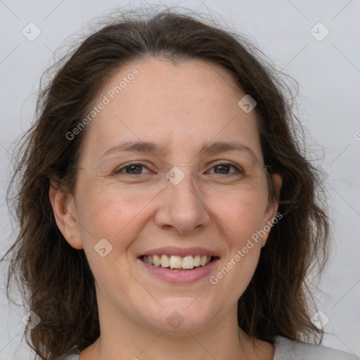 Joyful white adult female with medium  brown hair and grey eyes