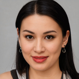 Joyful latino young-adult female with long  brown hair and brown eyes