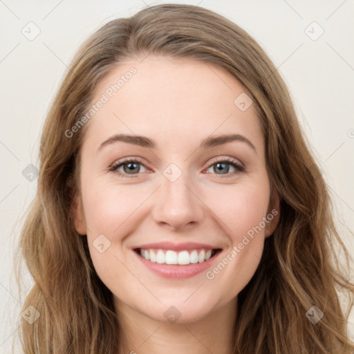 Joyful white young-adult female with long  brown hair and green eyes