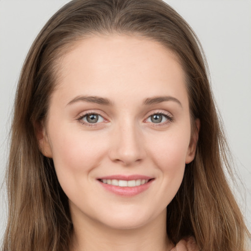 Joyful white young-adult female with long  brown hair and grey eyes