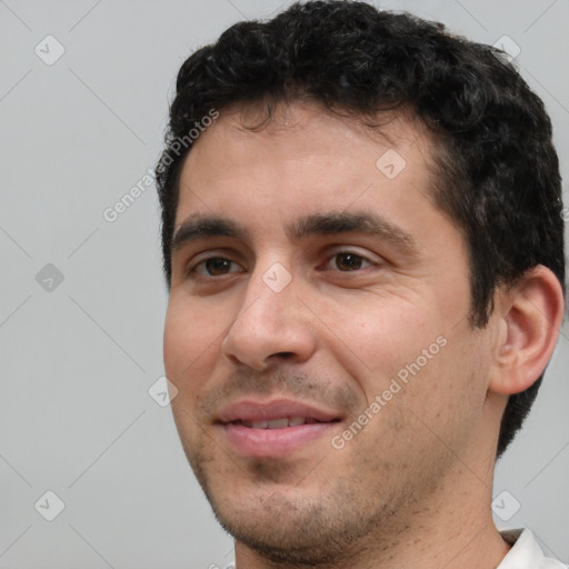 Joyful white young-adult male with short  black hair and brown eyes