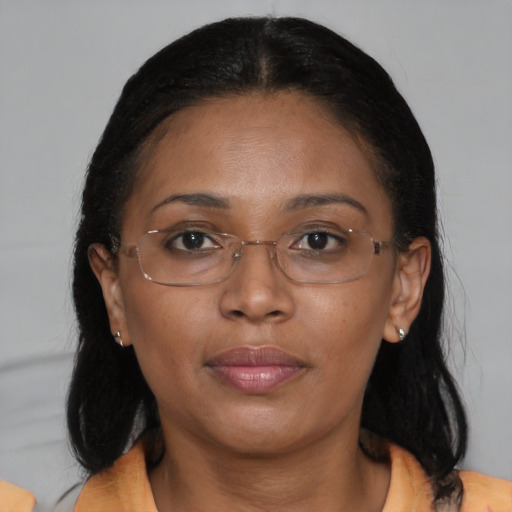 Joyful latino adult female with medium  brown hair and brown eyes