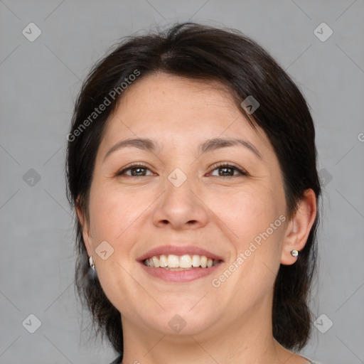 Joyful white adult female with medium  brown hair and brown eyes