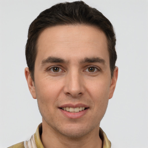 Joyful white young-adult male with short  brown hair and brown eyes