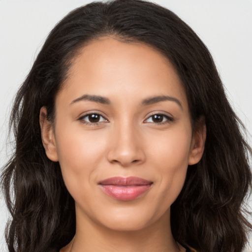 Joyful latino young-adult female with long  brown hair and brown eyes