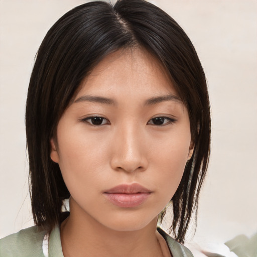 Neutral asian young-adult female with medium  brown hair and brown eyes