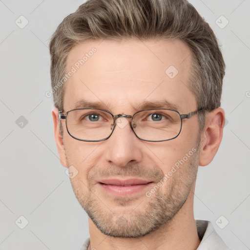 Joyful white adult male with short  brown hair and grey eyes