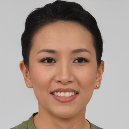 Joyful asian young-adult female with short  brown hair and brown eyes