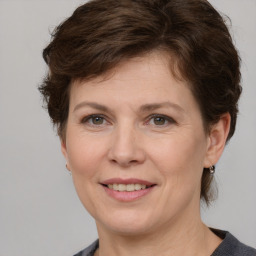 Joyful white adult female with short  brown hair and grey eyes