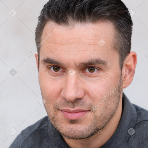 Joyful white adult male with short  brown hair and brown eyes