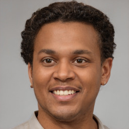 Joyful latino young-adult male with short  brown hair and brown eyes