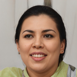 Joyful latino young-adult female with medium  brown hair and brown eyes