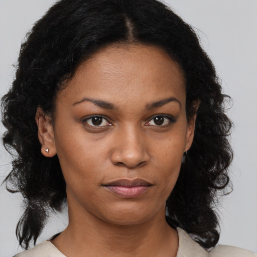 Joyful black young-adult female with medium  brown hair and brown eyes