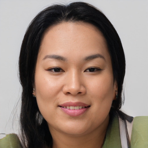 Joyful asian young-adult female with long  brown hair and brown eyes