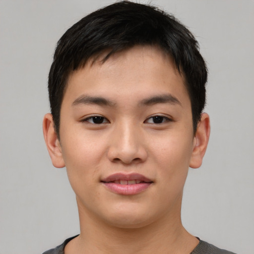 Joyful asian young-adult male with short  brown hair and brown eyes
