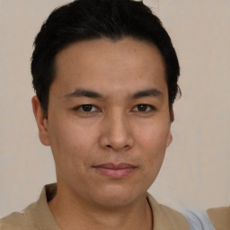 Joyful asian young-adult male with short  black hair and brown eyes