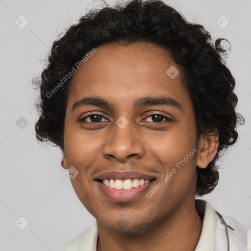 Joyful black young-adult male with short  brown hair and brown eyes