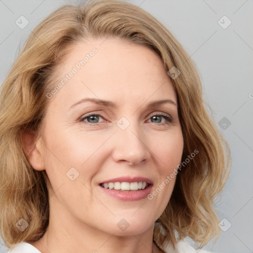 Joyful white adult female with medium  brown hair and blue eyes