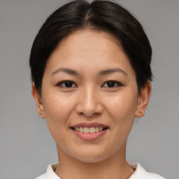 Joyful asian young-adult female with short  brown hair and brown eyes