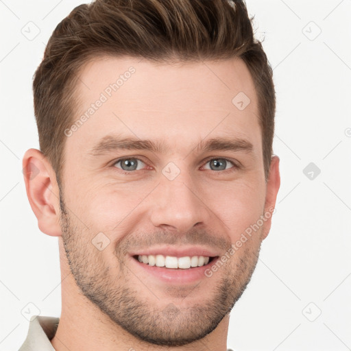 Joyful white young-adult male with short  brown hair and grey eyes