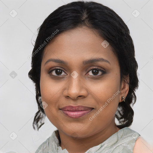 Joyful black young-adult female with medium  brown hair and brown eyes