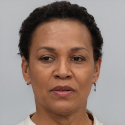 Joyful black adult female with short  brown hair and brown eyes