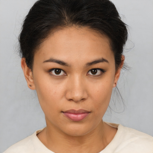 Joyful asian young-adult female with short  brown hair and brown eyes