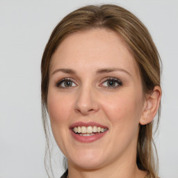 Joyful white young-adult female with medium  brown hair and blue eyes