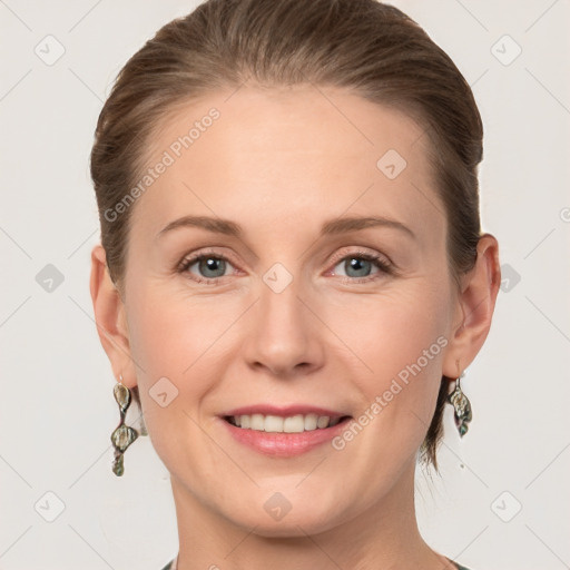 Joyful white adult female with medium  brown hair and grey eyes