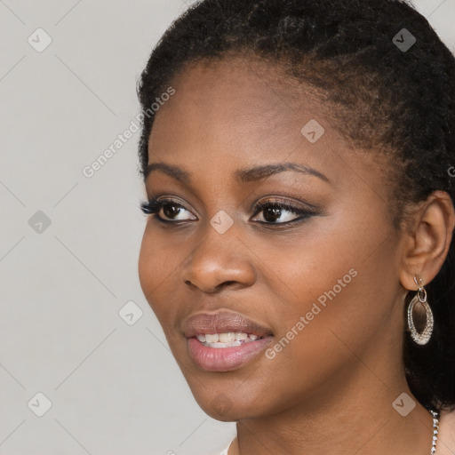 Joyful black young-adult female with long  black hair and brown eyes