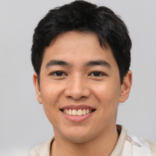 Joyful asian young-adult male with short  black hair and brown eyes