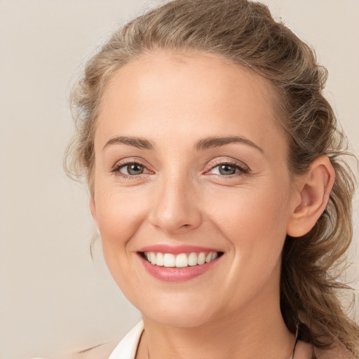 Joyful white young-adult female with long  brown hair and grey eyes