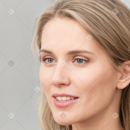 Joyful white young-adult female with long  brown hair and blue eyes