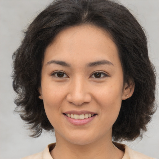 Joyful white young-adult female with medium  brown hair and brown eyes