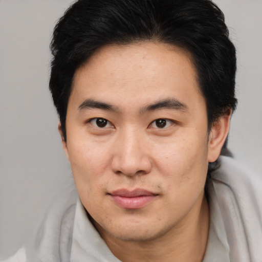 Neutral asian young-adult male with short  brown hair and brown eyes