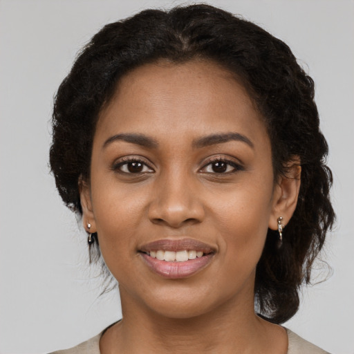 Joyful black young-adult female with medium  black hair and brown eyes