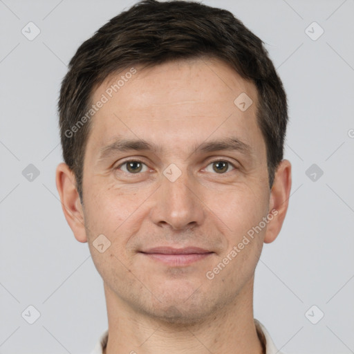 Joyful white adult male with short  brown hair and brown eyes