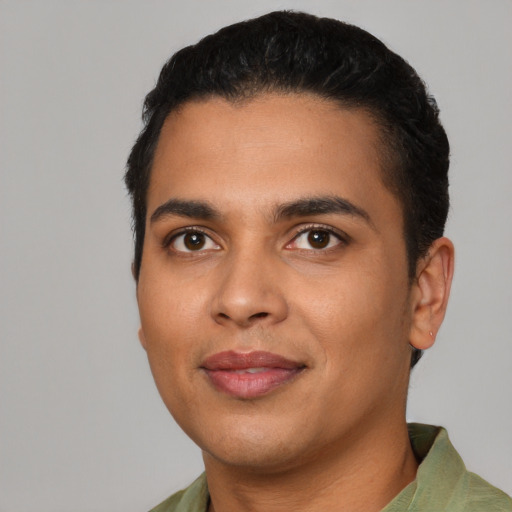 Joyful latino young-adult male with short  black hair and brown eyes