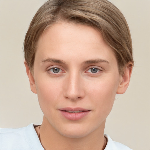 Joyful white young-adult female with short  brown hair and grey eyes