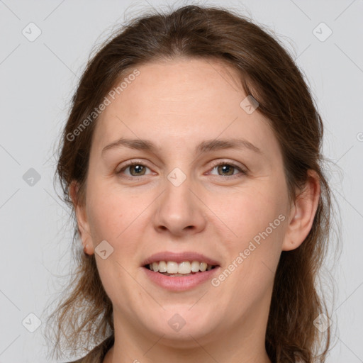 Joyful white young-adult female with medium  brown hair and grey eyes