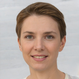 Joyful white young-adult female with short  brown hair and grey eyes