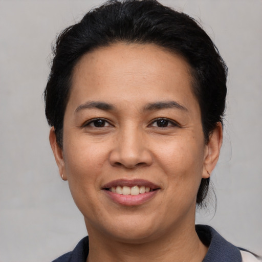 Joyful white adult female with short  black hair and brown eyes