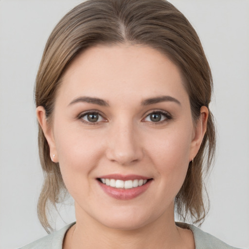 Joyful white young-adult female with medium  brown hair and brown eyes