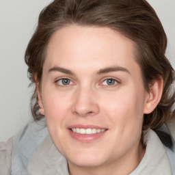 Joyful white young-adult female with medium  brown hair and green eyes