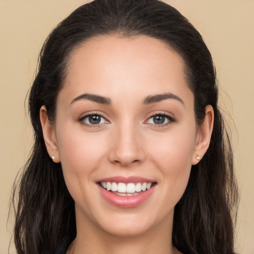 Joyful white young-adult female with long  brown hair and brown eyes