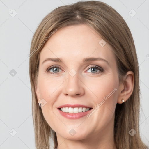 Joyful white young-adult female with long  brown hair and grey eyes