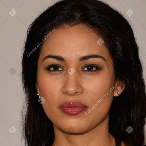 Joyful latino young-adult female with long  brown hair and brown eyes